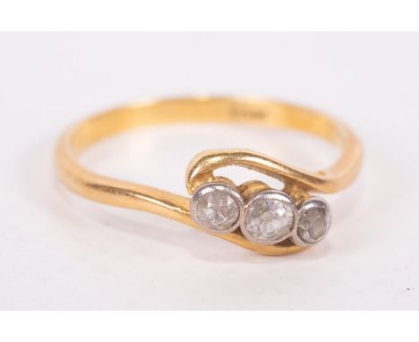 A three stone diamond set ring, in yellow metal stamped 18ct. Approximate weight 3.0 grams. Size P.