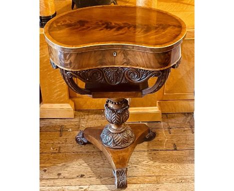 An early Victorian walnut and satinwood strung jewellery table, in a kidney shape, a hinged top enclosing trinket storage box