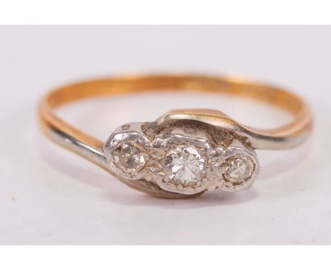An early 20th century diamond trilogy ring, in yellow metal stamped 18ct Plat. Gross weight approximately 2.3 grams. Size k.