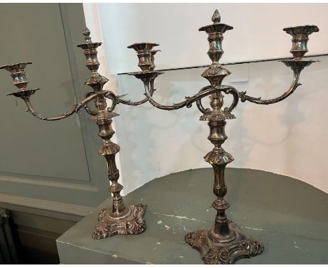 A pair of ornate silver plated three light candelabra, with removeable finnials/snuffers. The silver plate is rubbed and ther