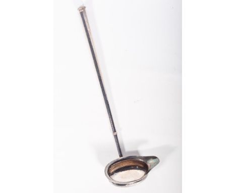 An Elizabeth II sterling silver hand raised toddy ladle. In the Old English revival style, hallmarked for William Comyns and 