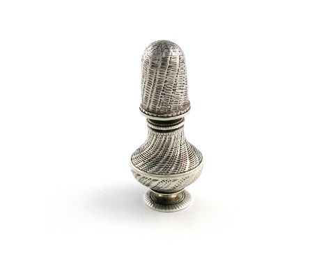 A silver thimble, cotton reel and caster, unmarked, possibly German or Italian, early 19th century, baluster form, engine-tur