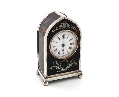 λAn Edwardian silver mantle clock, by William Comyns, London 1906, arched upright form, inlaid with foliate scroll decoration