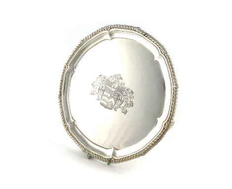 A George III silver salver, by Paul Storr, London 1813, gadrooned border, on four foliate bracket feet, the centre with an ar