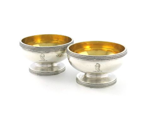 A pair of George III silver salt cellars, by Paul Storr, London 1802, circular form, with rope-work chevron borders, engraved