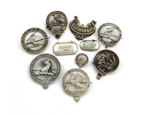 A collection of Scottish clan badges, one marked with a thistle, the others unmarked, circular form, for the families Cartwri