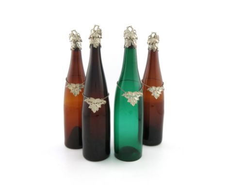 A matched set of four Victorian silver-mounted coloured glass bottles and a set of four Victorian wine labels, the bottle mou