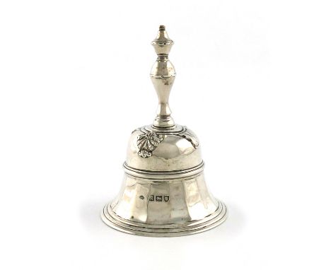 An Edwardian silver table bell, by William Comyns, London 1905, conventional panelled form, with applied shell and foliate mo