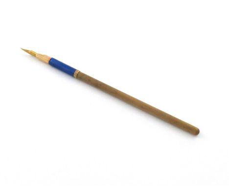 A Russian gold and enamel-mounted dip pen, marked 56, the mount with reeded decoration and with dark blue enamel, also with a