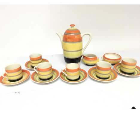 An Art Deco ceramic Grays Pottery Susie Cooper coffee set with bands of orange yellow and black one cup with a slight chip.