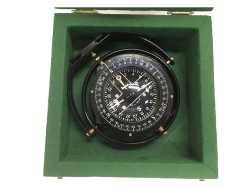A military type compass in a fitted box, box approx 24cm x 24cm.