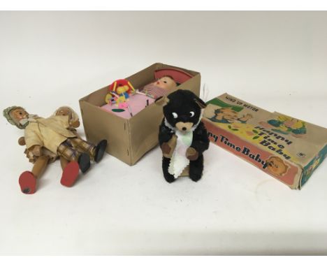 A Vintage clockwork Milk bear a boxed Happy Time Baby and two wooden dolls. (a lot) NO RESERVE