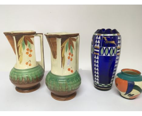 Two hand painted Myott porcelain jugs an Art Deco design blue glass vase and an Arabian ware hand painted pot no obvious dama