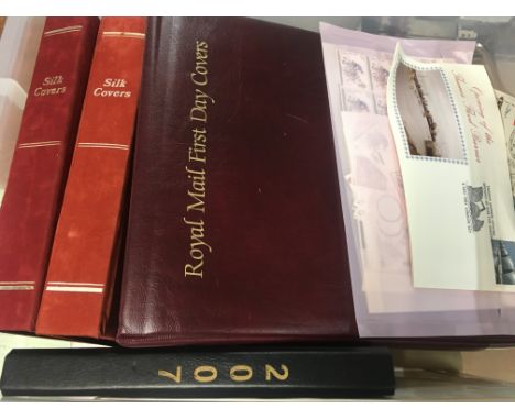 A box of first day covers, silk covers, postcards etc, including a quantity of unused stamps