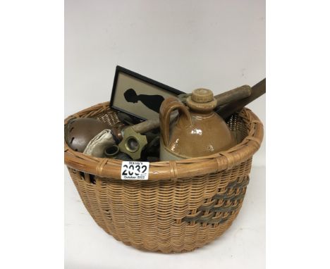 A basket containing vintage kitchen implements brass Corinthian column candle sticks and other oddments.