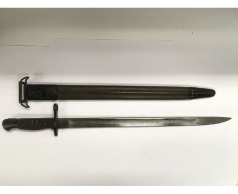 An American 1917 Remington bayonet with metal capped leather scabbard.