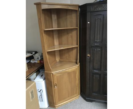A blonde Ercol modern design corner display unit with a cupboard. Under heigh 180cm