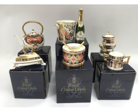 Six boxed Royal Crown Derby miniature items comprising a toy drum, champagne bottle and ice bucket, teapot and other items (6