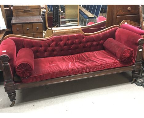 A late Regency mahogany sofa with a shaped back scroll cushions detachable seat cushion. On fluted legs terminating in brass 