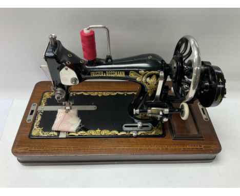 A cased Frister &amp; Rossman manual sewing machine.
