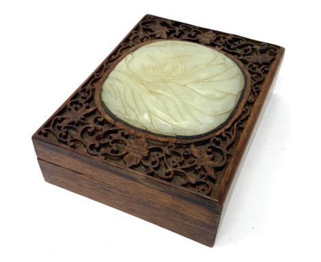 A CHINESE JADE-INSET WOOD BOX AND COVER, THE JADE 17TH / 18TH CENTURY the domed oval plaque carved with a bat in flight over 