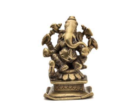 A SMALL BRASS FIGURE OF GANESHA, WESTERN DECCAN, INDIA, 17TH / 18TH CENTURY the four-armed pot-bellied elephant headed deity 