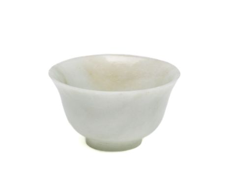 A CHINESE JADE BOWL plain, carved after a porcelain shape with deep sides and slightly everted rim, on short foot, pale celad