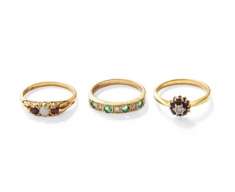 Three Gem Set Rings, comprising of an 18 carat gold ruby and diamond cluster ring, finger size O1/2; a 9 carat gold emerald a