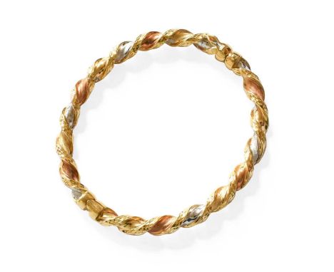 A Tri-Colour Hinged Bangle, of twist design, with applied plaque stamped '750', inner measurments 6.4cm by 5.4cmStamped '750'