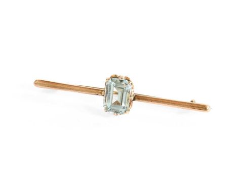 An Aquamarine Bar Brooch, the emerald-cut aquamarine in a yellow claw setting, to a kinfe edge bar, length 5.4cmAquamarine me