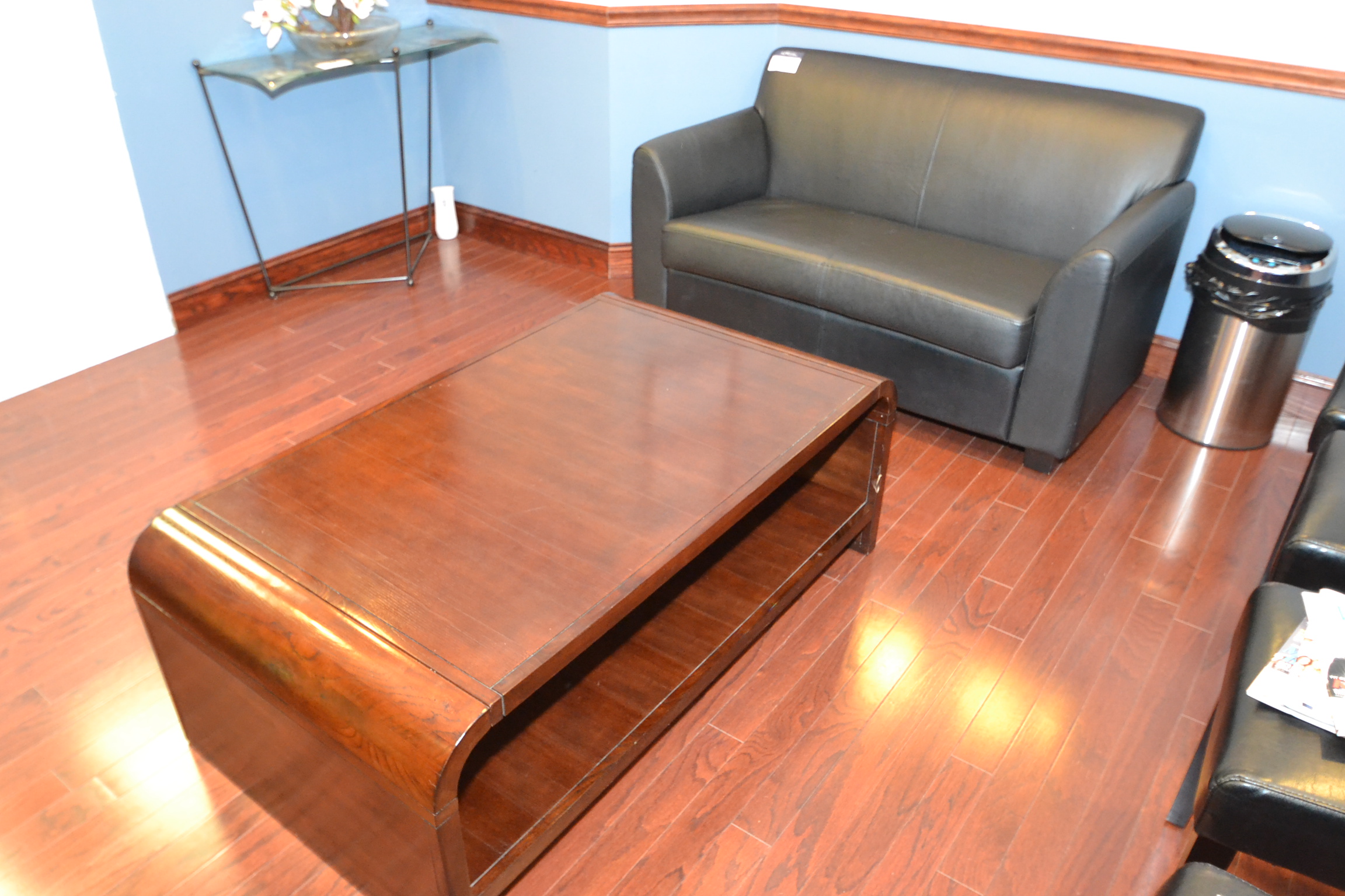 black leather sofa with a wood coffee table