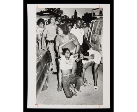 Keith Graham, Miami Herald Staff Photographer. Original press photograph captioned "Daisey McKinney helping girl in shock at 