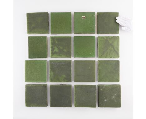 Grueby Faience Company, Boston, Massachusetts. Group of 16 American Arts and Crafts enameled green ceramic pottery tiles, lat