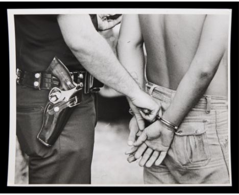 Michael E. Keating, Cincinnati Enquirer. Original press photograph captioned "Cuffs &amp; Gun" depicting a close-up of a poli