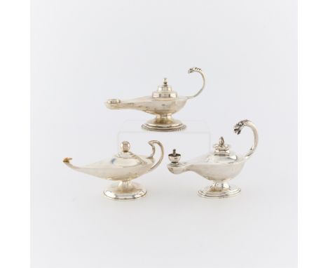 Group of three silver lamp form table lighters. Including:One sterling silver lamp form table lighter, of plain design with c