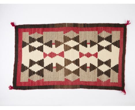 Vintage Navajo rug or wool weaving featuring a regional pattern, 1930s. The carpet depicting a central field of interlocking 