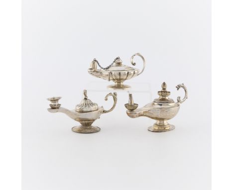 Group of three silver lamp form table lighters. Including:One sterling silver lamp form table lighter, with snuff cap, marked