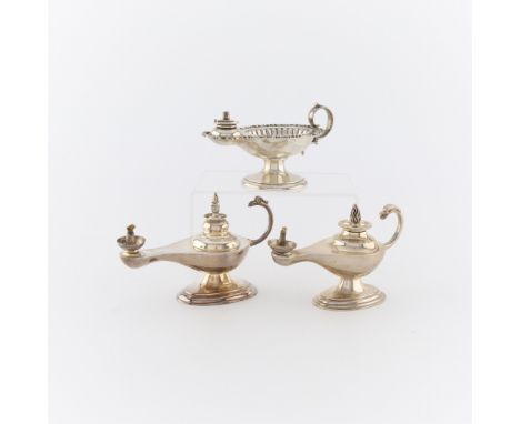 Group of three silver lamp form table lighters. Including:One sterling silver lamp form table lighter, of plain design with b