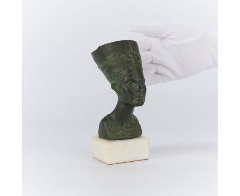 Small Italian bronze bust depicting the Egyptian Queen Nefertiti atop a white stone base, 20th century. Stamped "Made in Ital