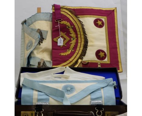 Masonic ornamental red leather backed frontispiece and a brown leather case with white gloves and a blue sash, labelled “Toye