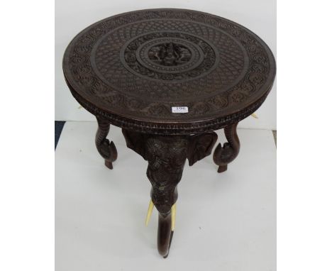 Carved Indian Occasional Table with elephant head and trunk shaped legs, bone tusks, 24” dia