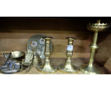 Shelf of brassware – pair low candlesticks, church candlestick, bell, figure of dog etc