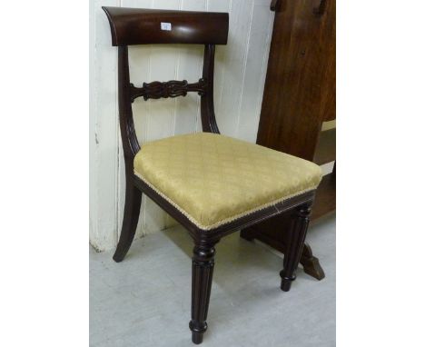 A William IV mahogany framed dining chair with a curved bar crest and carved, horizontal splat, the braided old gold coloured
