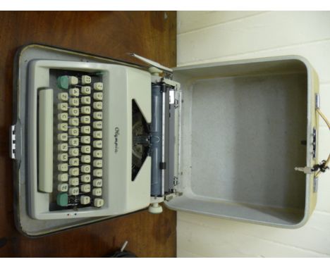 A mid 20thC Olympia portable manual typewriter, in a two tone canvas bound carrying case       CA