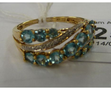 A 9ct gold ring, set with parallel bands of blue topaz and diamonds       11    