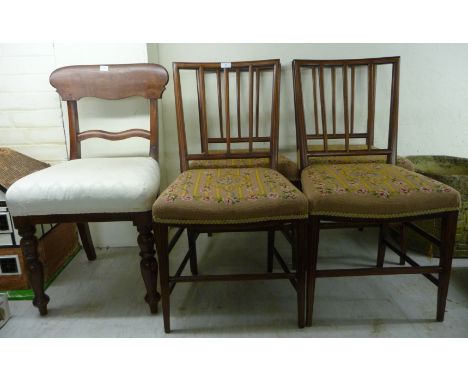 A set of four Edwardian string inlaid mahogany framed dining chairs with square, railed backs and tapestry upholstered, overs