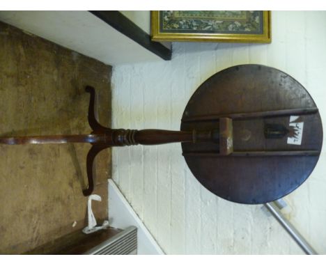 A George III string inlaid mahogany pedestal tip-top table, raised on a baluster column and tripod base  28''h  18''dia      