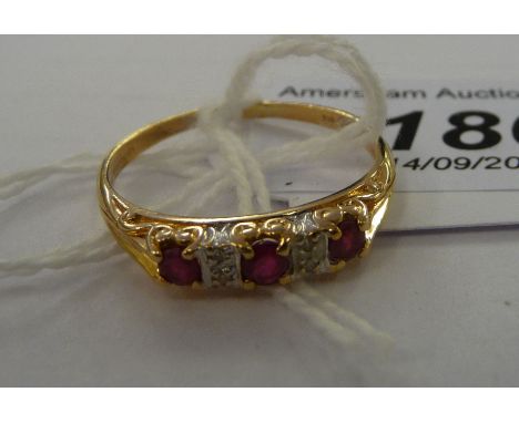 A 9ct gold claw set ruby and diamond ring         11   