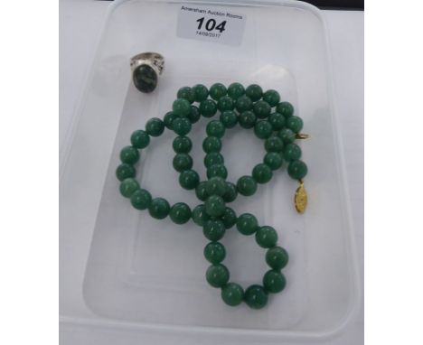 A green bead necklace; and a silver coloured metal ring, set with a green stone       11