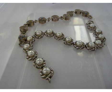 A silver bracelet, set with floral beads; and a white metal, freshwater pearl set bracelet       11     